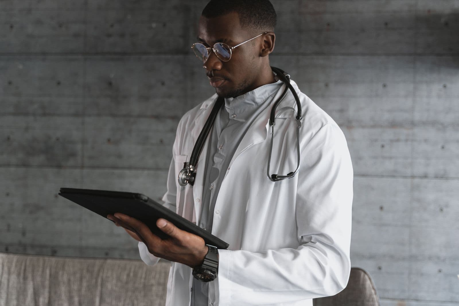A clinician reviewing work on a tablet